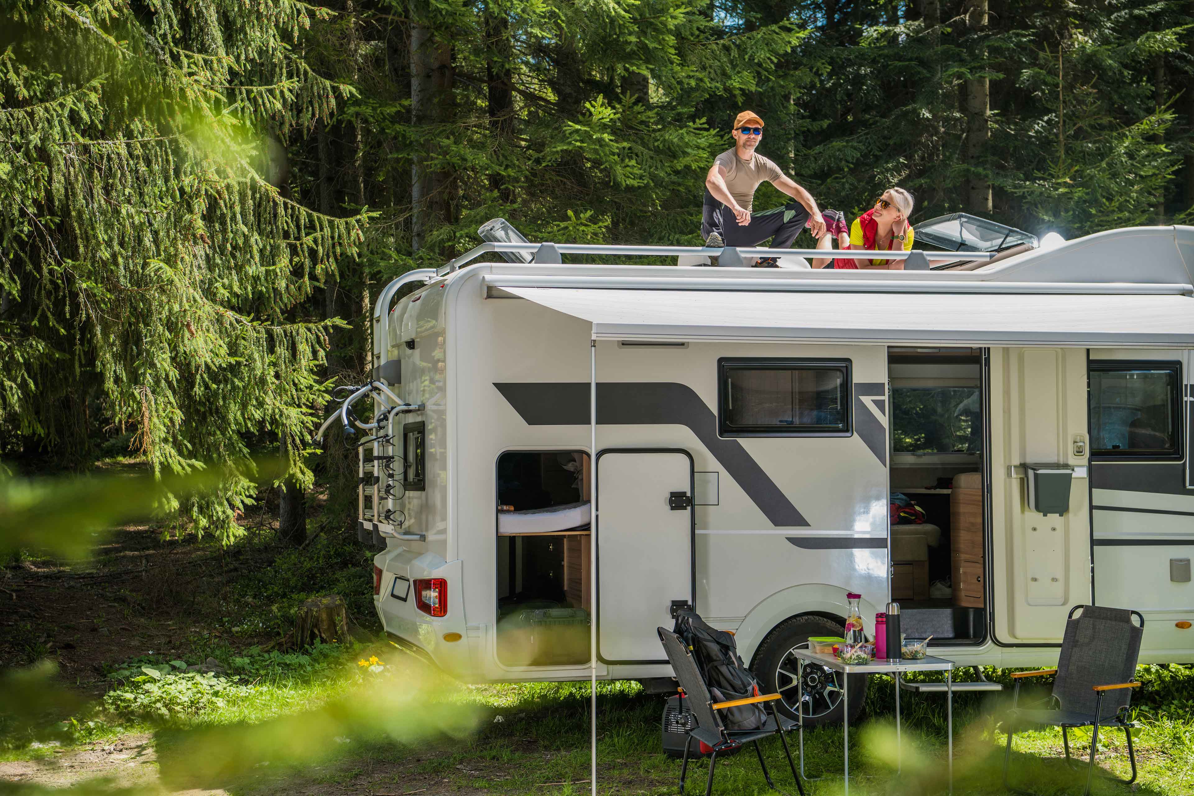 happy family relaxing roof their rv