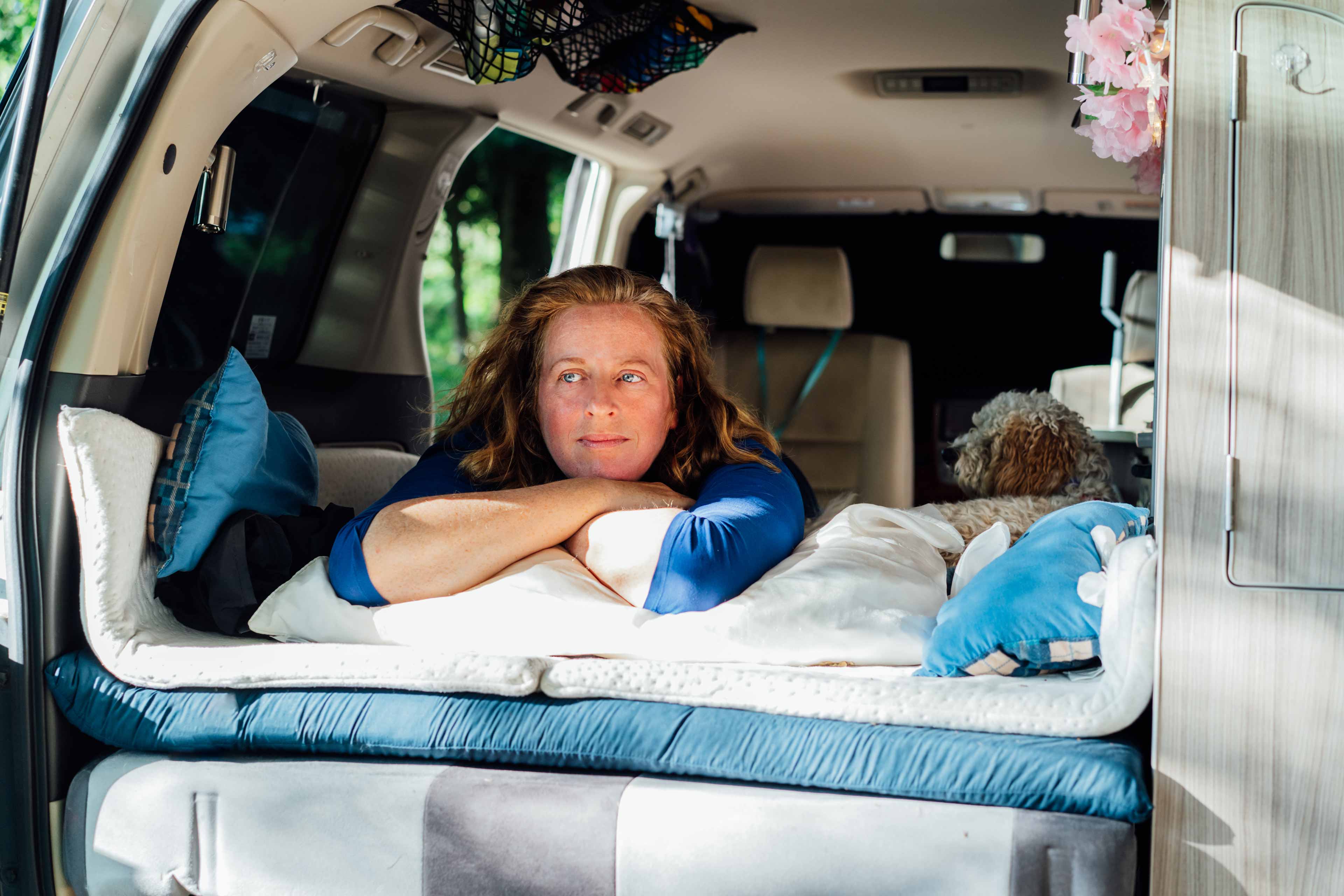 middle aged woman relaxing lying in camper car