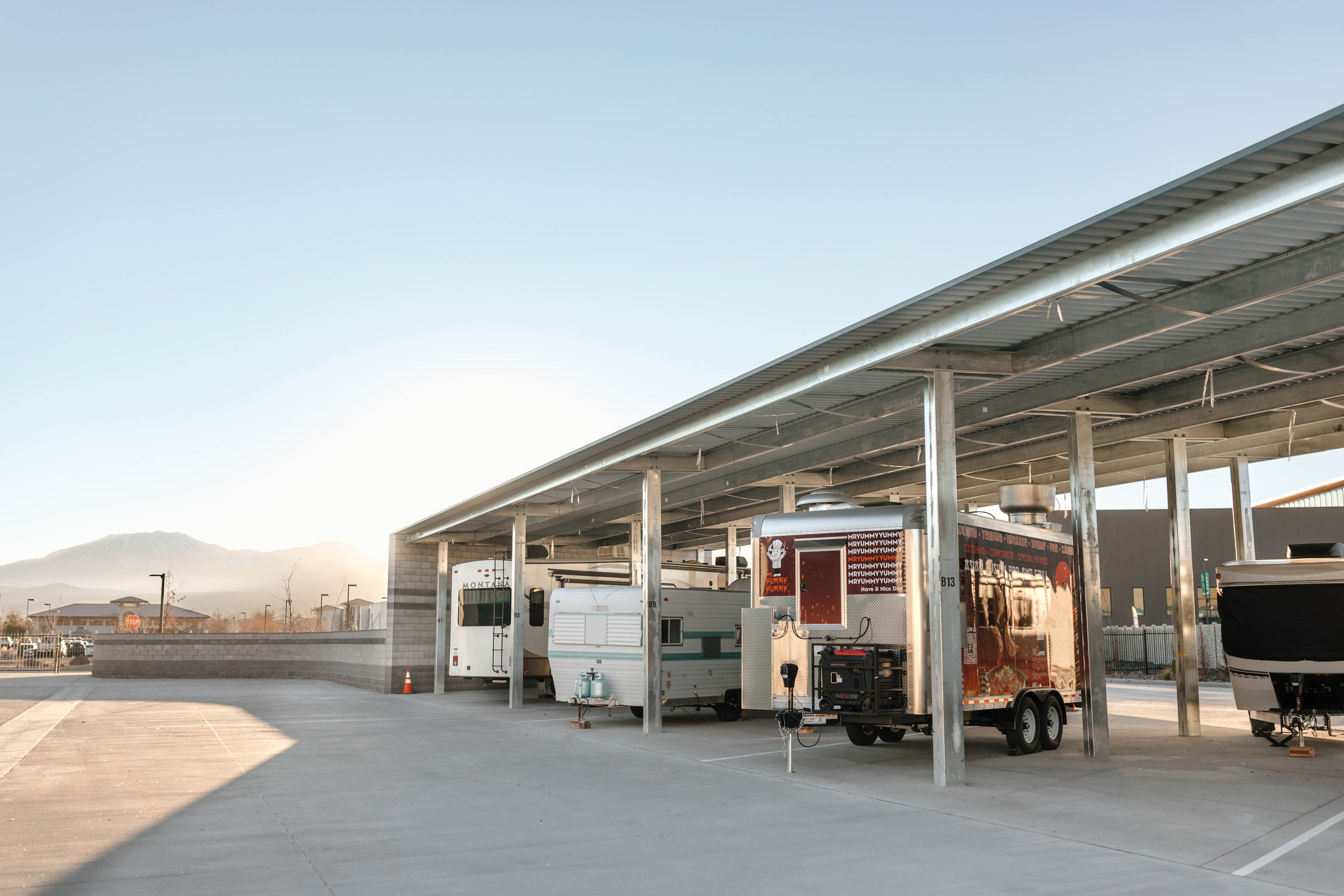 RV trailers and food truck under covered storage at South Meadows Reno